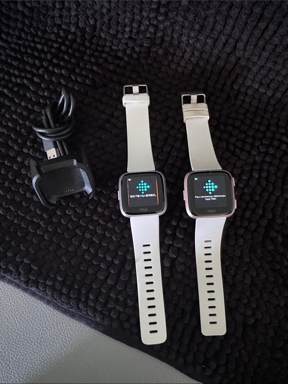 fitbit Versa and Lite Smartwatches with White Bands and Charger